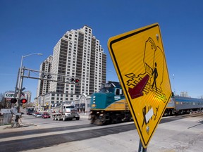 This level crossing on London?s Ridout Street has full warning gates and signals, but many in our region do not. (CRAIG GLOVER, The London Free Press)