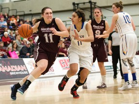 MacEwan University Griffins' Paige Knull (11) battles the University of Victoria Vikes' Marissa Dheensaw (11) during second half Canada West basketball action at MacEwan University on March 5. MacEwan won 77-62. (David Bloom)