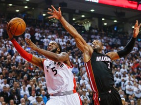 DeMarre Carroll of the Raptors drives past Miami Heat's Dwyane Wade in Game 2. (Stan Behal, Toronto Sun)