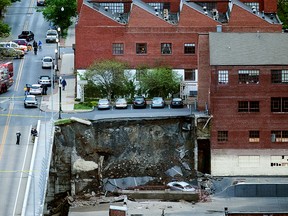 Police officers and firefighters keep the Mulberry Street Bridge clear of pedestrians after a retaining wall of the bridge collapsed in Harrisburg, Pa., Thursday, May 5, 2016. (Sean Simmers/PennLive.com via AP)