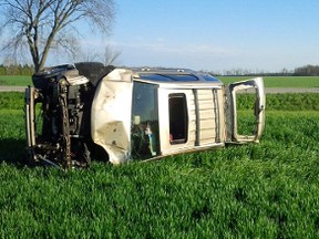 The passenger of an SUV died Thursday after it went into a ditch on Petrolia Line and rolled several times before coming to rest in a farmer's field. The single-vehicle accident happened in St. Clair Township at 4:45 p.m. The two adults and two children also in the vehicle were taken to hospital with unknown injuries. The photo was provided by Lambton OPP, via Twitter. (Handout)