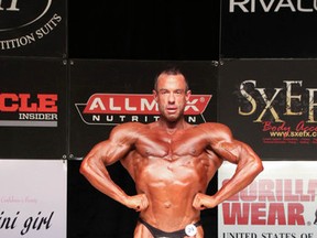 Jason Kowalchuk, 41, posing with his trophies during the Festival City Bodybuilding Championship held in Stratford last April. Submitted photo.