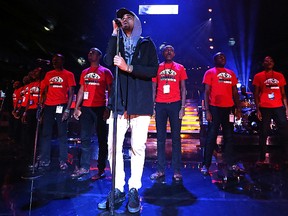 Canadian hip hop artist JRDN (right) performs with the Kenyan Boys Choir during WE Day at MTS Centre last year. (Kevin King/Winnipeg Sun file photo)