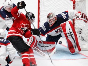 Canada's Brad Marchand (left) attacks the net of Keith Kinkaid of the United States during world hockey championship action in St. Petersburg, Russia, on Friday, May 6, 2016. (Dmitri Lovetsky/AP Photo)