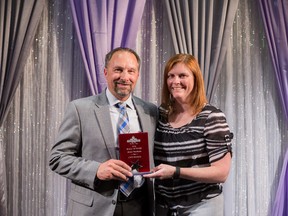 DRHBA president Heidi Stephenson presents Jamie MacInnis with the Hall of Fame Award.