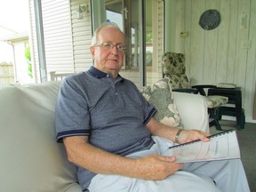 Larry Scully, president of the Carruthers Foundation, on Thursday June 25, 2015 in Sarnia, Ont.,  holds a history of the Sarnia foundation that is set to end its operations, after six decades of support for education and health care, in May 2016  (Paul Morden/Sarnia Observer/Postmedia Network)