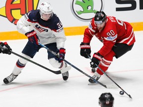Auston Matthews (left) of the United States challenges Canada’s Ryan O’Reilly during the world championship match in St. Petersburg, Russia, Friday, May 6, 2016. (AP Photo/Dmitri Lovetsky)