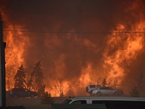 A wall of fire rages outside of Fort McMurray, Alta. The wildfire has burned several neighbourhoods in the Alberta city and threatens others, forcing the evacuation of the entire city. Canadians have reached out in compassion and empathy, as they have in other national disasters. (CBC/THE CANADIAN PRESS)