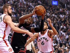 Miami Heat guard Dwyane Wade (3) battles to get past Toronto Raptors centre Jonas Valanciunas (17) and guard Cory Joseph (6) during Game 2 of the second round of the NBA playoffs Thursday at the Air Canada Centre. (Dan Hamilton/USA TODAY Sports)