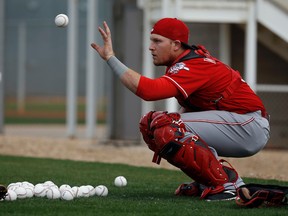 Cincinnati Reds catcher Devin Mesoraco catches a ball during a spring training workout Thursday, Feb. 18, 2016, in Goodyear, Ariz. (AP Photo/Morry Gash)