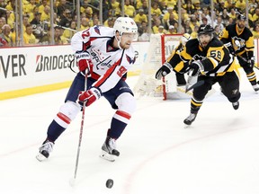 Washington Capitals centre Evgeny Kuznetsov gathers the puck ahead of Pittsburgh Penguins defenceman Kris Letang during third-period Game 3 action in the second round of the NHL playoffs at the CONSOL Energy Center in Pittsburgh on May 2, 2016. (Charles LeClaire/USA TODAY Sports)