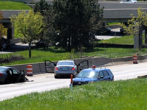 Michigan State Police investigate a shooting along westbound Interstate 94, between the 3rd St. overpass and The Lodge, Friday afternoon, May 6, 2016 in Detroit. Authorities say two people have been shot while traveling in a car on the highway, leaving part of the freeway closed. (Todd McInturf/Detroit News via AP)