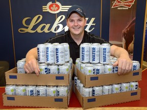 Brewmaster Cory Kummer shows off some of the  69,000 cans of drinking water Labatt is donating to evacuees and firefighters in wildfire-ravaged Fort McMurray, Alta. The brewer has another 131,000-plus cans ready to ship if needed. (MORRIS LAMONT, The London Free Press)
