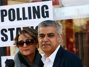 Sadiq Khan, Britain's Labour Party candidate for Mayor of London and his wife Saadiya pose for photographers after casting their votes for the London mayoral elections at a polling station in south London Britain May 5, 2016. REUTERS/Stefan Wermuth
