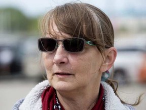 A tear runs down the cheek of Fort McMurray wildfire evacuee Linda De Marco at the evacuation centre at the Edmonton Expo Centre.