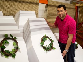 Okra Abdulah shows off mock coffins that will be used Saturday as part of a silent protest by Syrian refugees of atrocities in Syria, including destruction of a Canadian-supported hospital in Aleppo. The event also will offer community prayers for the nearly 90,000 people evacuated from wildfire-ravaged Fort McMurray, Alta. (MIKE HENSEN, The London Free Press)