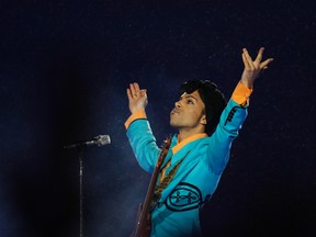 In this Feb. 4, 2007, file photo, Prince performs during the halftime show at Super Bowl XLI at Dolphin Stadium in Miami. (AP Photo/Alex Brandon, File)