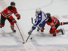 Toronto Marlies’ Rinat Valiev skates through Albany Devils Pierre-Luc Letourneau-Leblond (left) and Ben Thomson at Ricoh Coliseum. (Dave Thomas, Toronto Sun)