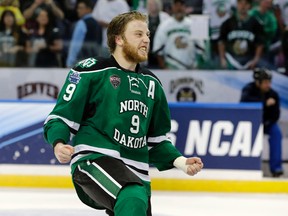 North Dakota forward Drake Caggiula (9) celebrates the team's 5-1 over Quinnipiac during an NCAA Frozen Four championship college hockey game Saturday, April 9, 2016, in Tampa, Fla.