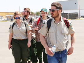 John Lappa/Sudbury Star
FireRangers from the Ontario Ministry of Natural Resources and Forestry prepare to board a plane in Sudbury that is being deployed to Fort McMurray, Alta., on Friday. The firefighters will assist in battling the fires in that region.