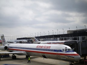 An American Airlines airplane sits at a gate at the O'Hare Airport in Chicago, Illinois, in this file photo taken October 2, 2014. The Federal Aviation Administration said American Airlines experienced nationwide ground stops on Thursday.   REUTERS/Jim Young/Files