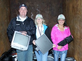 From left, security manager Mike McDonald, casino manager Nora Jennings and kitchen supervisor Babette Healy show old electronics donated to an e-waste collection on Saturday, May 7, 2016 in Point Edward, Ont. Funds raised from the program will go to Friends of Pinery Park. Terry Bridge/Sarnia Observer/Postmedia Network