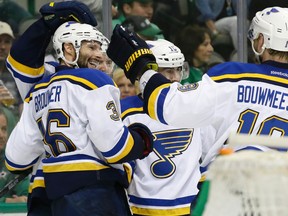 St. Louis Blues right wing Troy Brouwer (36) celebrates scoring his goal with teammates Jay Bouwmeester (19), Robby Fabbri (15) and others during the second period of Game 5 of the NHL hockey Stanley Cup playoffs Western Conference semifinals against the Dallas Stars Saturday, May 7, 2016, in Dallas. (AP Photo/LM Otero)