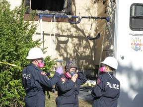 Calgary Poilice and firefighters investigate a fire on Falchurch Cr. N.E. in Calgary, Alta on Saturday May 7, 2016. Five people, all believed to be adults died at the scene. Jim Wells/Postmedia