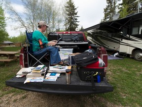 Eileen Drover looks through photographs rescued from her Fort McMurray home when her family was forced to evacuate because of the wildfire. They are now staying in a campground that has been opened for evacuees at Beaver Lake near Lac La Biche.