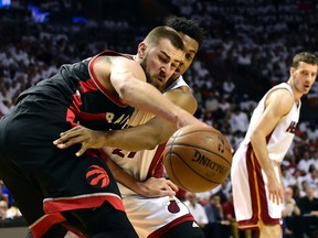Toronto Raptors centre Jonas Valanciunas (17) and Miami Heat centre Hassan Whiteside reach for a loose ball during Game 3 Saturday at AmericanAirlines Arena. (Steve Mitchell/USA TODAY Sports)