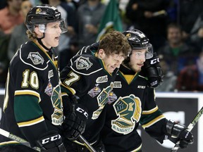 London Knights forward Matthew Tkachuk is helped off the ice by line mates Christian Dvorak and Victor Mete after injuring his knee while scoring a goal against the Niagara Ice Dogs during game 2 of their OHL championship hockey series at Budweiser Gardens in London, Ont. on Saturday May 7, 2016. The Knights won the game 6-1, taking a 2-0 lead in the series.  Craig Glover/The London Free Press/Postmedia Network
