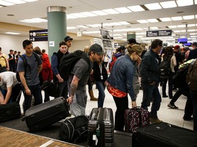 Fire evacuees from Fort McMurray claim their luggage at the Edmonton International Airport on Saturday, May 6, 2016.