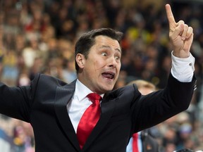 Team Canada's head coach Guy Boucher reacts during the match between Switzerland's HC Davos and Team Canada at the 89th Spengler Cup hockey tournament in Davos, Switzerland, Wednesday, Dec. 30, 2015. Boucher has been hired as the new head coach of the Ottawa Senators. (Pascal Muller/The Canadian Press)