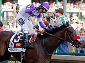 CORRECTS LAST NAME TO GUTIERREZ FROM GUITIERREZ - Mario Gutierrez celebrates after riding Nyquist to victory during the 142nd running of the Kentucky Derby horse race at Churchill Downs Saturday, May 7, 2016, in Louisville, Ky. (AP Photo/Garry Jones)