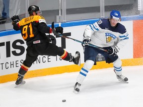 Patrik Laine of Finland in action with Moritz Muller of Germany. (REUTERS/Maxim Zmeyev)