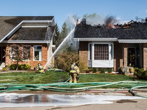 A home at 212 Wolf Ridge Close burns in Edmonton, Alta., on Sunday, May 8, 2016. (CODIE MCLACHLAN PHOTO)