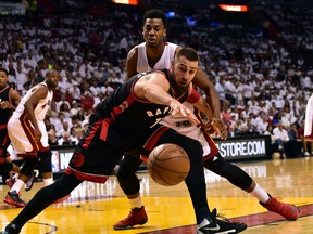 Toronto Raptors center Jonas Valanciunas and Miami Heat center Hassan Whiteside both reach for a loose ball during the first quarter in game three of the second round of the NBA Playoffs at American Airlines Arena. (Steve Mitchell/USA TODAY Sports)