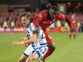 Toronto FC's Jozy Altidore battles Dallas defender Walker Zimmerman during Saturday night's 1-0 win. (Reuters)