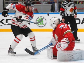 Canada's Taylor Hall (left) attacks the net of goalkeeper Dmitri Milchakov of Belarus during world hockey championship action in St.Petersburg, Russia, on Monday, May 9, 2016. (Dmitri Lovetsky/AP Photo)