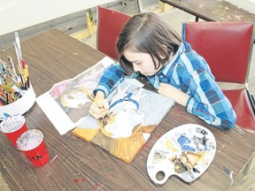 Koen Martin, 11, finishes off a portrait of a dog at his father Francis' business, The Art Shop in Watford. The Grade 6 student has almost 20 commissions to paint people's pooches. (Carl Hnatyshyn, Postmedia Network)