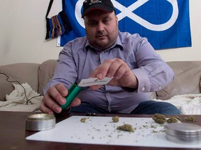 Clayton Goodwin prepares medicinal marijuana at his apartment in Ottawa, Friday March 20, 2015.  THE CANADIAN PRESS/Adrian Wyld