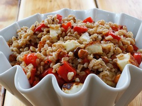 This March 14, 2016 photo, shows a chickpea and farro salad in Concord, N.H. It combines savory roasted chickpeas with grill hallmoumi cheese and nutty cooked farro for a light, but hearty spring salad. (AP Photo/J.M. Hirsch)