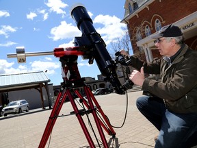 Emily Mountney-Lessard/The Intelligencer
Don Town, national council representative for the Belleville Centre of the Royal Astronomical Society of Canada, adjusts his telescope during a public viewing of the planet Mercury transit hosted at Market Square on Monday.