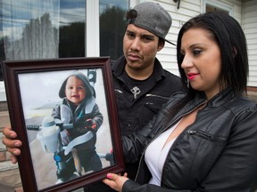 Julie Bilotta, the woman who gave birth to a son while being held at the Ottawa Detention Centre, is seen here with her spouse Dakota Garlow with a favourite photo of their son Gionni who died shortly after turning one year old.
