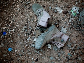 In this Sunday, March 20, 2016 photo, combat boots lie at the scene of fierce battles between Islamic State militants and Iraqi security forces, weeks after Iraq regained control of the city of Ramadi. (AP Photo/Maya Alleruzzo)