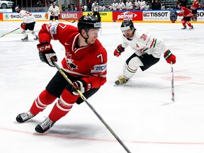 Canada’s Michael Matheson (left) controls the puck as Hungary’s Frank Banham forechecks during the world hockey championship in St. Petersburg, Russia, on Sunday, May 8, 2016. (Dmitri Lovetsky/AP Photo)