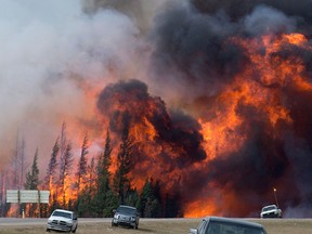 A giant fireball is seen as a wildfire rips through the forest along Highway 63, 16 kilometres south of Fort McMurray, Alta., Saturday, May 7, 2016. THE CANADIAN PRESS/Jonathan Hayward