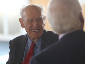 George Muirhead talks to former Kingston mayor and MPP John Gerretsen.
(Elliot Ferguson/The Whig-Standard)