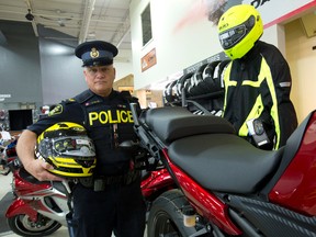 Wearing highly-visible gear helps motorcyclists stay safe, says OPP Sgt. Dave Rektor, seen here Monday with safety gear at London retailer Hully Gully. (CRAIG GLOVER, The London Free Press)