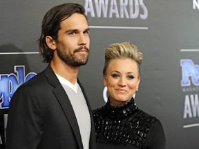 In this Dec. 18, 2014 file photo, Ryan Sweeting, and his wife Kaley Cuoco arrive at the People Magazine Awards at the Beverly Hilton in Beverly Hills, Calif. Cuoco, the star of "The Big Bang Theory," is divorcing Sweeting after less than two years of marriage. Cuoco's representative, Melissa Kates, said Saturday, Sept. 26, 2015 that the actress and the tennis pro have "mutually decided to end their marriage." The couple wed in a New Year's Eve ceremony in 2013. (Photo by Chris Pizzello/Invision/AP, File)
